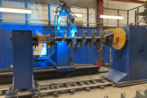 Robot do much of the complex welding - here welding a beater for a rear discharge spreader in 2022.